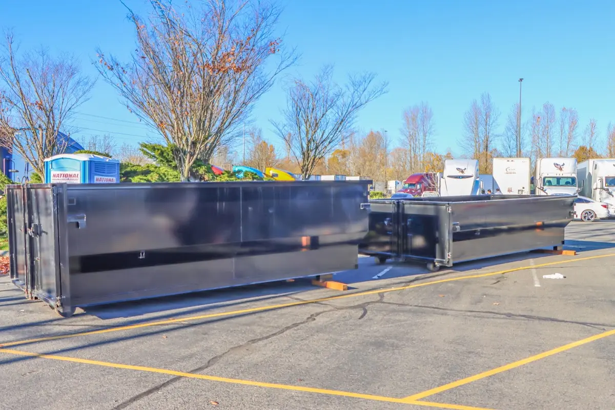 Professional dumpster rental service with roll-off container on residential driveway in Lincoln Village